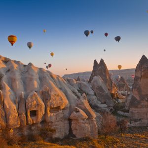  - Hot Air Balloons rise up over the Goreme Valley in Cappadocia, Turkey